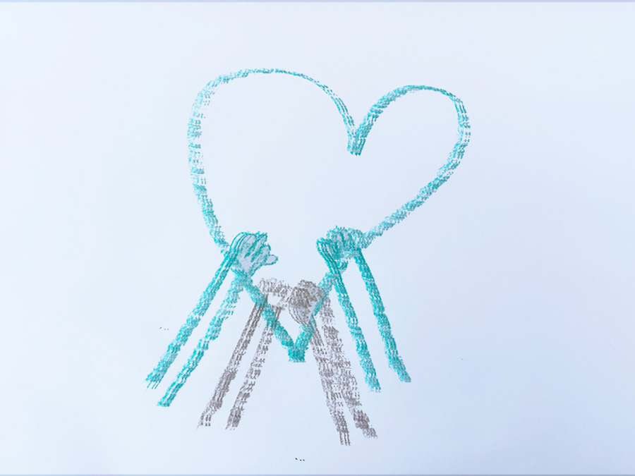 A heart drawn in turquoise marker, held up by two small hands.